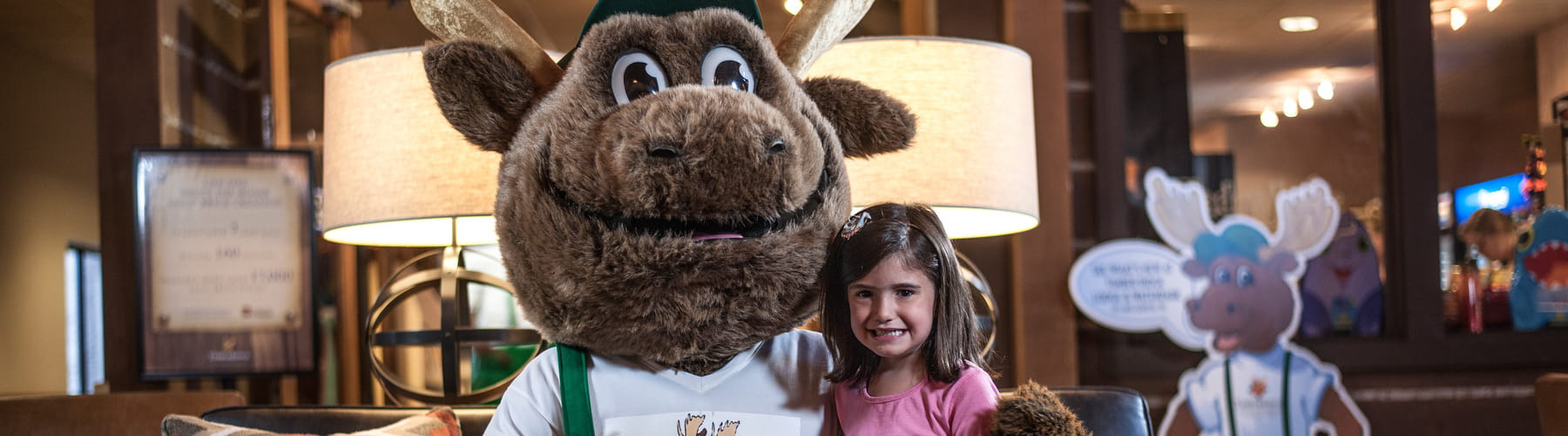 Bruce the Moose with a young girl